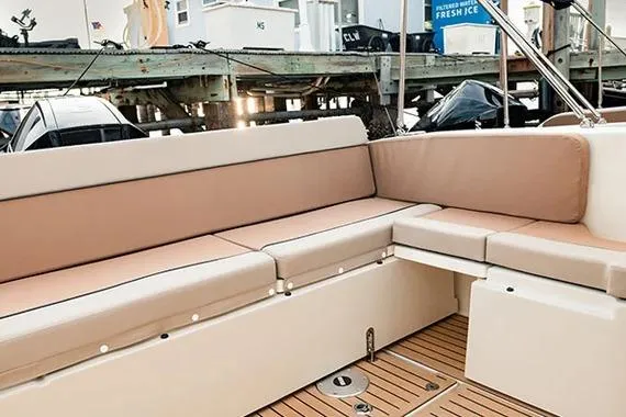 Slide: The Image of 2026 Trophy T25EX EXPLORER OB boat with beige seating and wooden deck. - 8