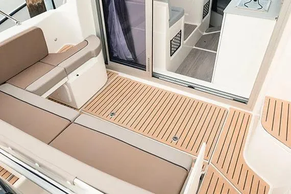 Slide: The Image of 2026 Trophy T25EX EXPLORER OB boat interior with beige seating and wood flooring. - 9