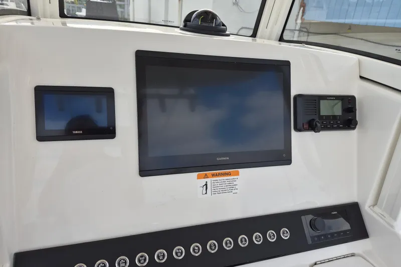 Slide: The Image of 2026 Regulator 25 boat dashboard with Garmin and Yamaha displays. - 11