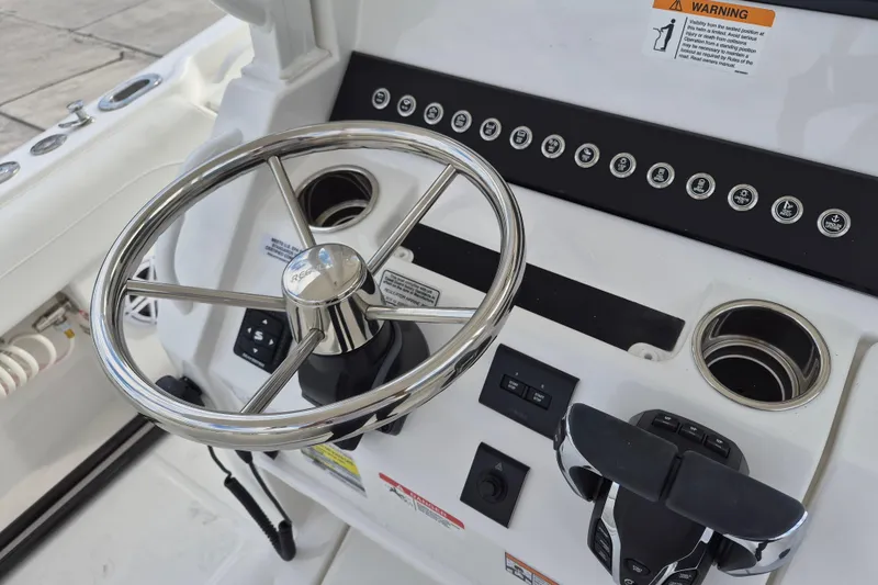 Slide: The Image of Steering wheel and controls of 2026 Regulator 25 boat cockpit. - 12