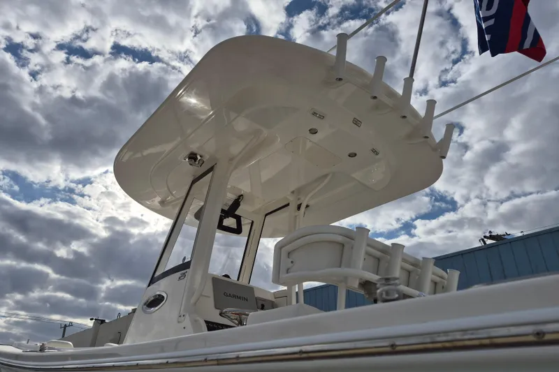 Slide: The Image of 2026 Regulator 25 boat with T-top against a cloudy sky background. - 18