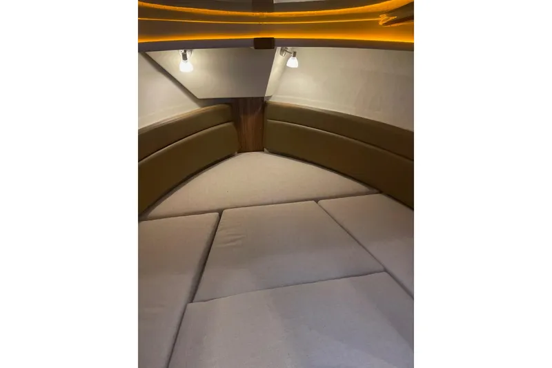 Slide: The Image of 2026 Ranger Tug R-27 interior cabin with cozy seating and ambient lighting. - 10