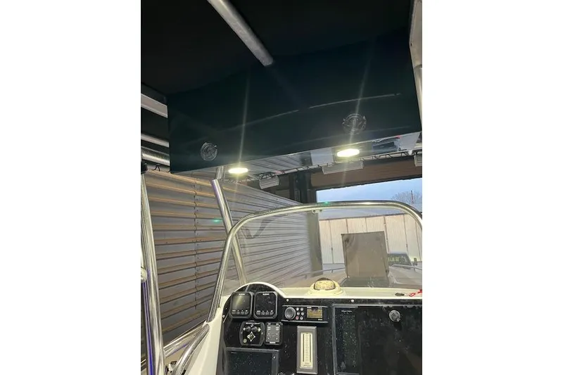 Slide: The Image of 2002 Baja 340 Islander Outboard boat interior with dashboard and overhead lighting. - 11