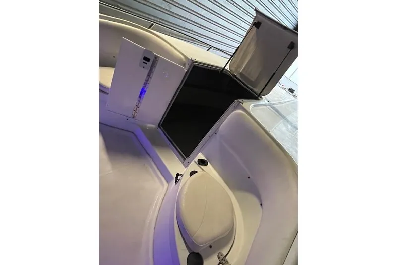 Slide: The Image of 2002 Baja 340 Islander Outboard boat interior with open storage compartments. - 7