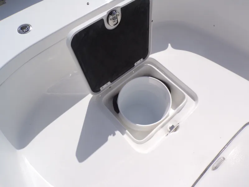 Slide: The Image of Tidewater 2500 Carolina Bay 2026 boat, open storage compartment with bucket. - 7
