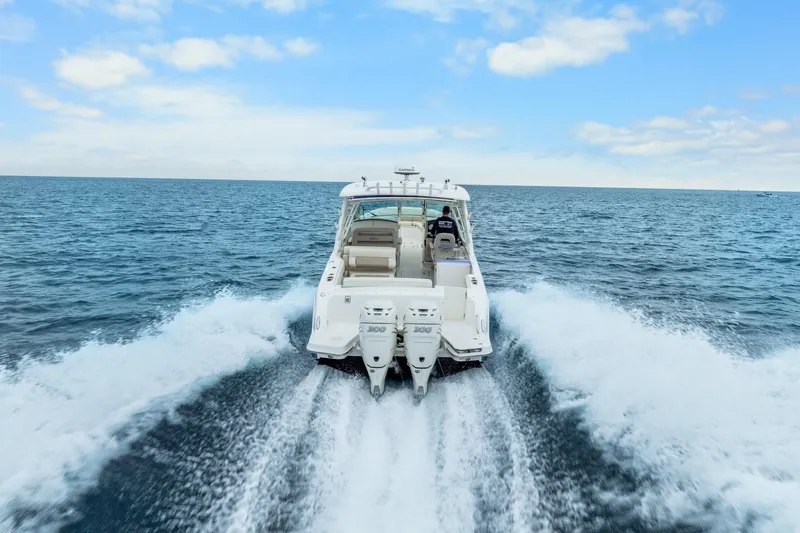 Slide: The Image of 2018 Boston Whaler 320 Vantage cruising on open ocean waters. - 10