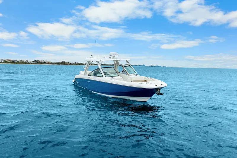 Slide: The Image of 2018 Boston Whaler 320 Vantage boat on open blue sea under clear sky. - 12