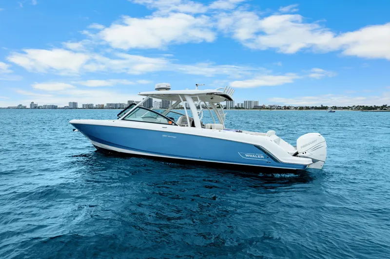Slide: The Image of 2018 Boston Whaler 320 Vantage boat on open water, clear sky background. - 17