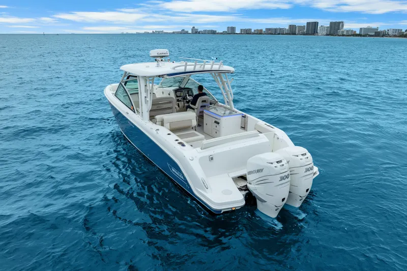 Slide: The Image of 2018 Boston Whaler 320 Vantage boat on blue ocean near city skyline. - 18