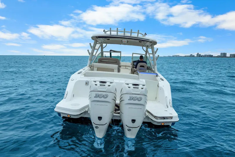 Slide: The Image of 2018 Boston Whaler 320 Vantage boat on open water, twin engines visible. - 19