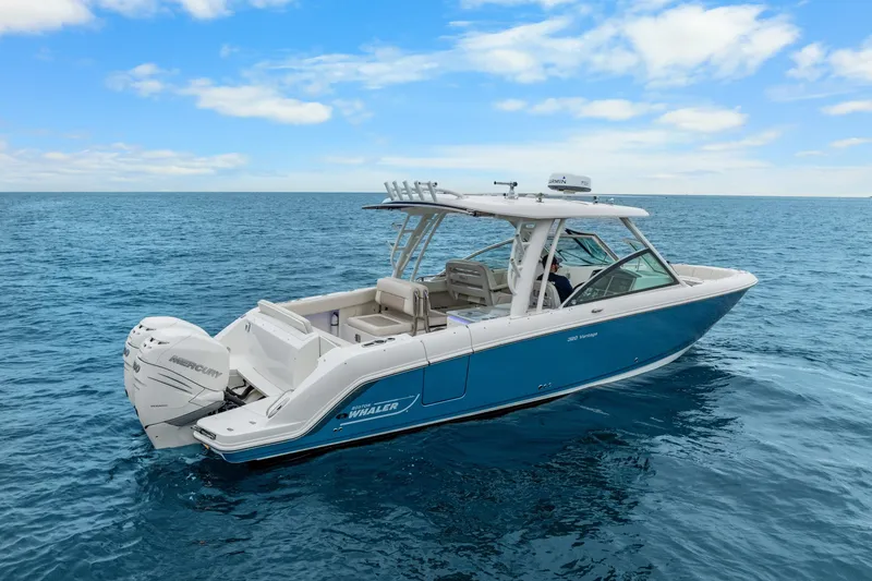 Slide: The Image of 2018 Boston Whaler 320 Vantage boat cruising on open blue sea. - 20