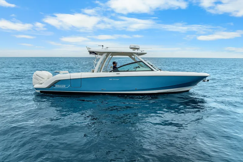 Slide: The Image of 2018 Boston Whaler 320 Vantage boat on open sea under blue sky. - 21