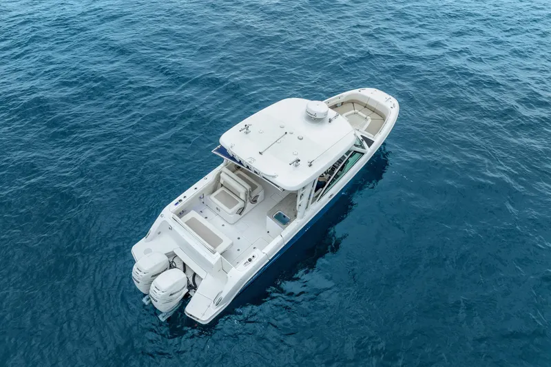 Slide: The Image of 2018 Boston Whaler 320 Vantage boat on open blue water. - 22