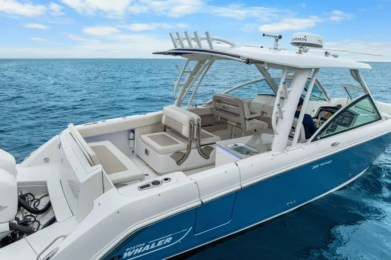 Slide: The Image of 2018 Boston Whaler 320 Vantage boat on open sea, featuring sleek design and spacious seating. - 24