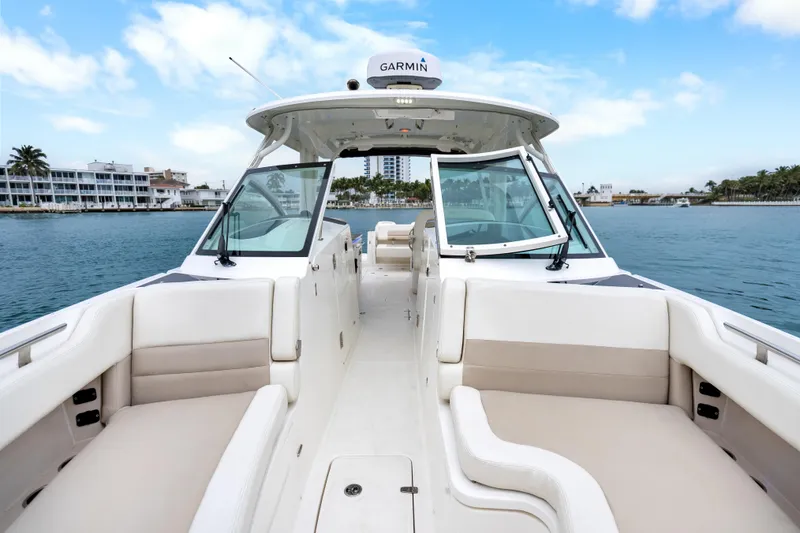 Slide: The Image of 2018 Boston Whaler 320 Vantage boat interior with open seating, on calm water. - 30