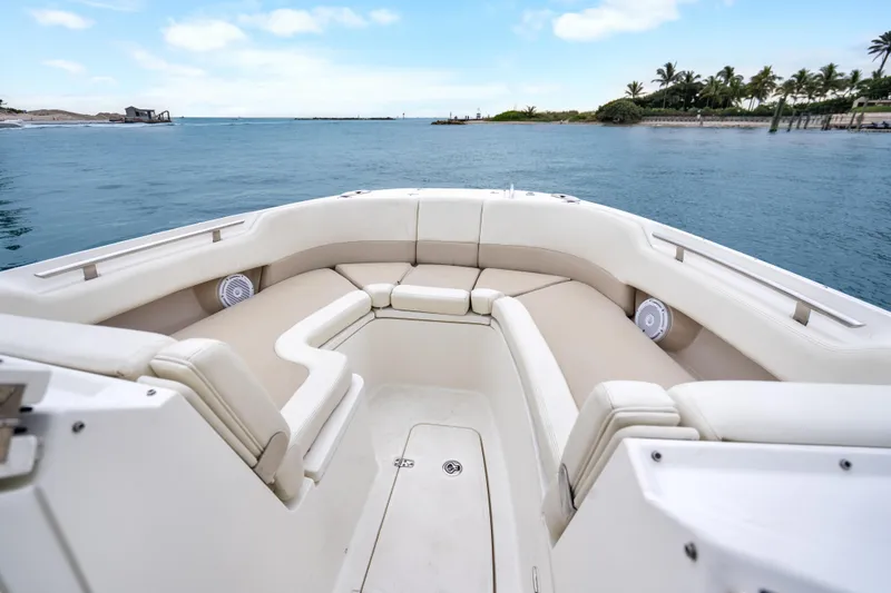Slide: The Image of 2018 Boston Whaler 320 Vantage boat interior with beige seating, ocean view. - 32