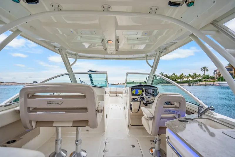 Slide: The Image of 2018 Boston Whaler 320 Vantage boat interior with helm, seating, and ocean view. - 35
