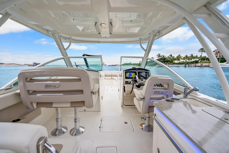 Slide: The Image of 2018 Boston Whaler 320 Vantage boat interior with helm, seating, and ocean view. - 36