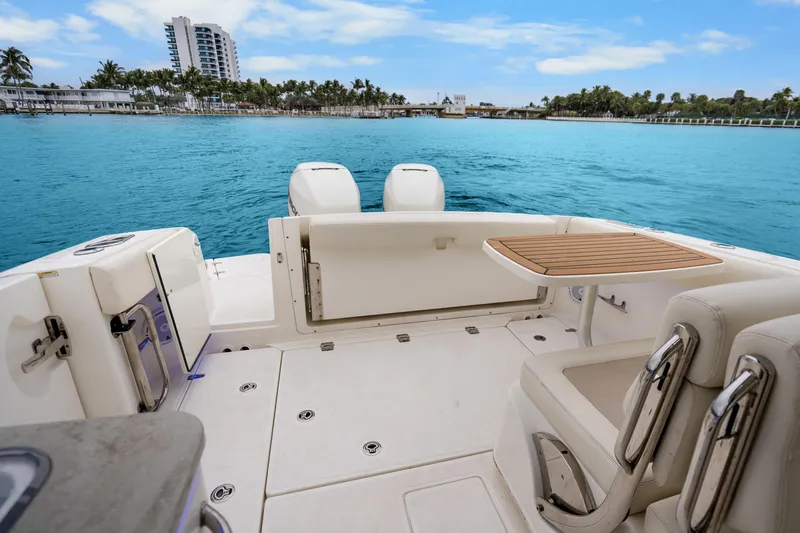 Slide: The Image of 2018 Boston Whaler 320 Vantage boat interior with ocean view and seating area. - 41