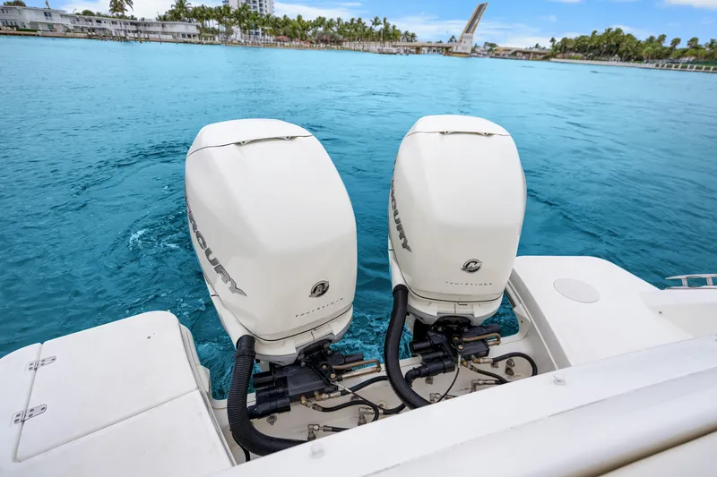Slide: The Image of 2018 Boston Whaler 320 Vantage with twin Mercury outboard engines on blue water. - 46