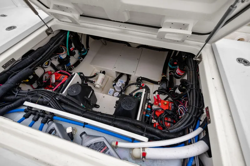Slide: The Image of 2018 Boston Whaler 320 Vantage engine compartment with wiring and components visible. - 47