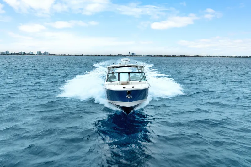 Slide: The Image of 2018 Boston Whaler 320 Vantage cruising on open water under a clear sky. - 6