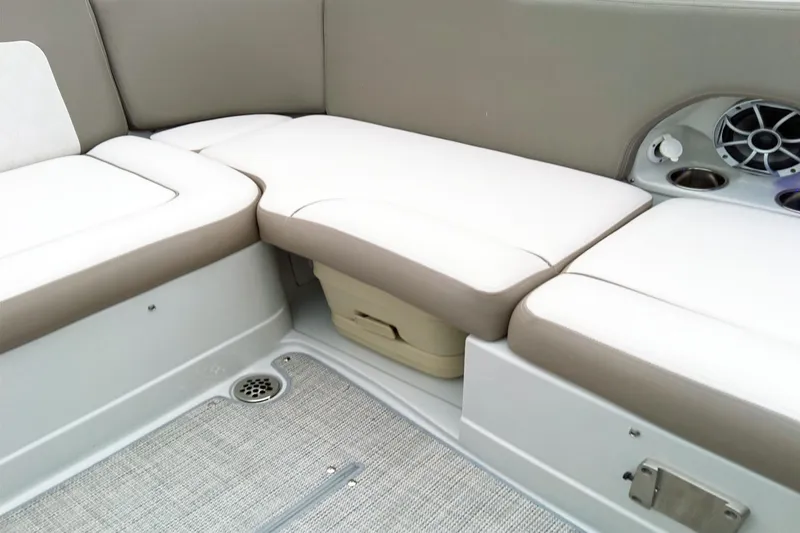 Slide: The Image of 2024 Crownline Eclipse E210 XS boat interior with beige seating and speaker system. - 11