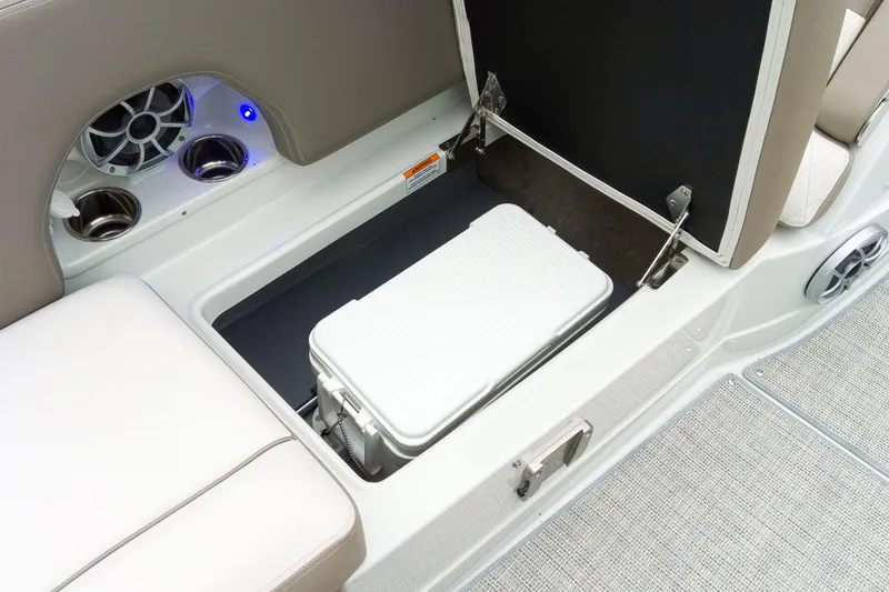 Slide: The Image of 2024 Crownline Eclipse E210 XS boat interior with storage compartment and cooler. - 17