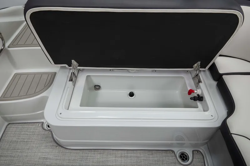 Slide: The Image of 2024 Crownline Eclipse E210 XS boat storage compartment with open lid, showcasing interior features. - 20
