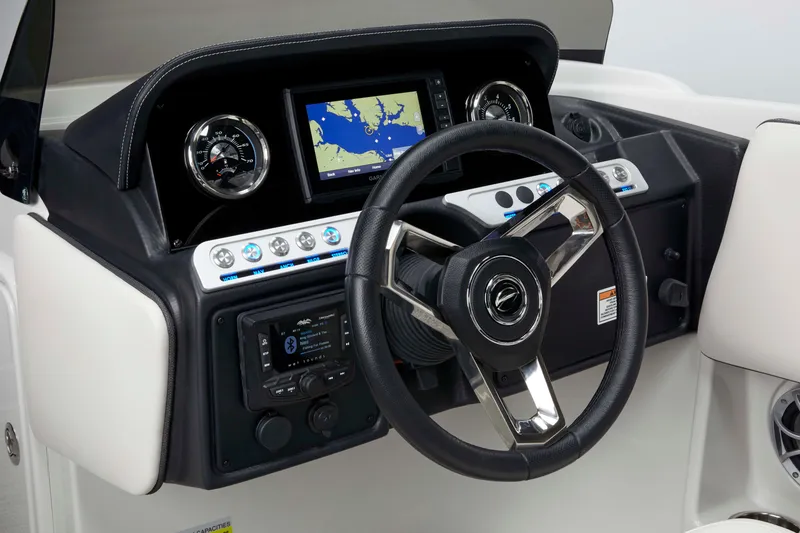 Slide: The Image of 2024 Crownline Eclipse E210 XS dashboard with steering wheel and navigation display. - 4