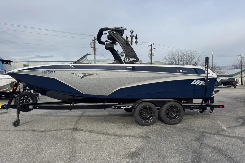 Slide: The Image of 2022 Tigé Z3 boat on trailer, sleek design, blue and silver color scheme. - 0