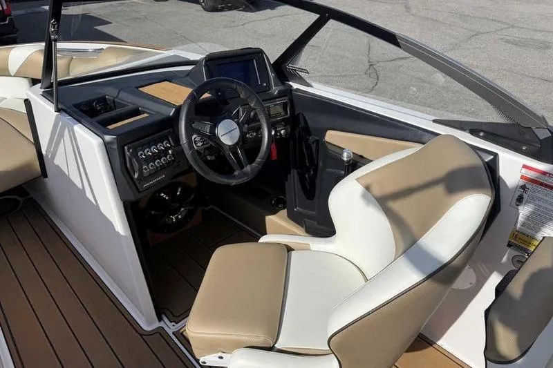 Slide: The Image of 2022 Moomba Craz boat interior with steering wheel and control panel. - 14