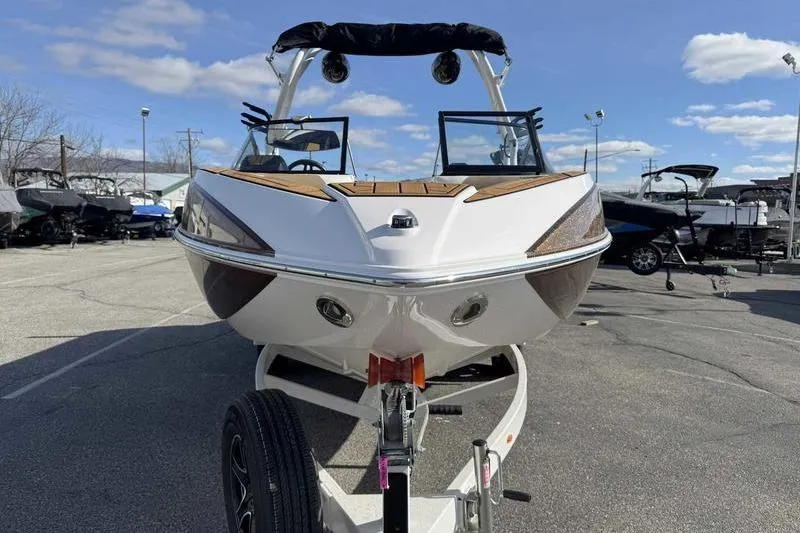 Slide: The Image of 2022 Moomba Craz boat on trailer under clear blue sky. - 5