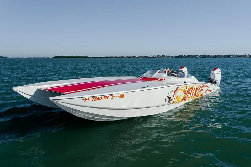 Slide: The Image of 2022 HellKats 32 speedboat with flame graphics cruising on open water. - 10