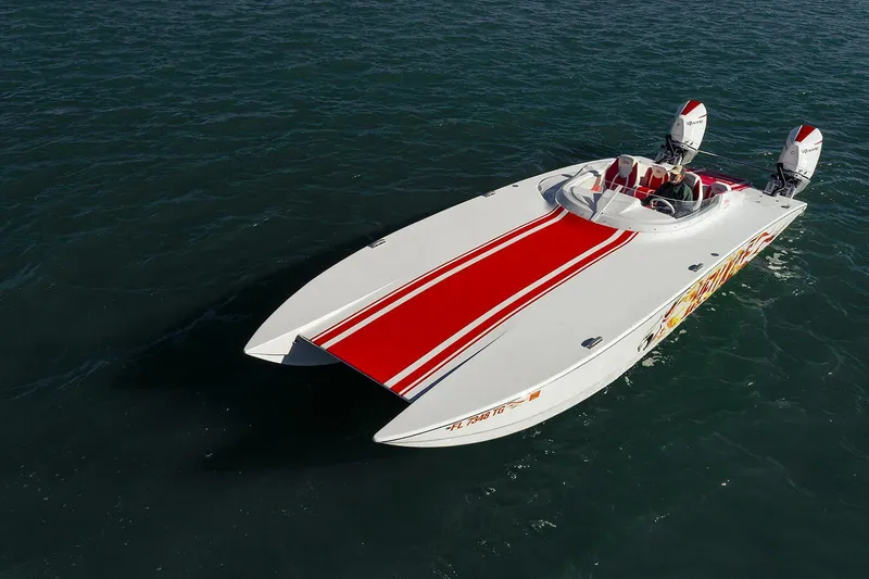 Slide: The Image of 2022 HellKats 32 speedboat with red stripes on open water. - 11