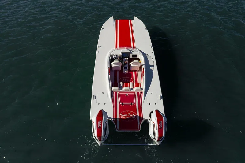 Slide: The Image of 2022 HellKats 32 boat with red and white design on water. - 15