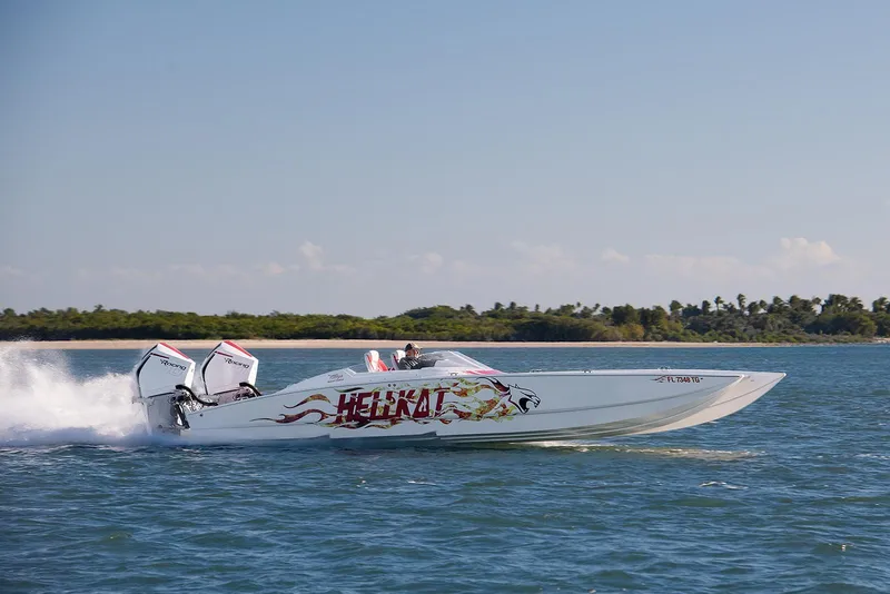 Slide: The Image of 2022 HellKats 32 speedboat cruising on water with vibrant graphics and twin engines. - 16
