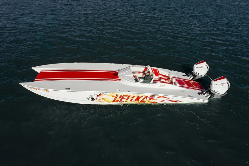 Slide: The Image of 2022 HellKats 32 speedboat with vibrant red accents on open water. - 19