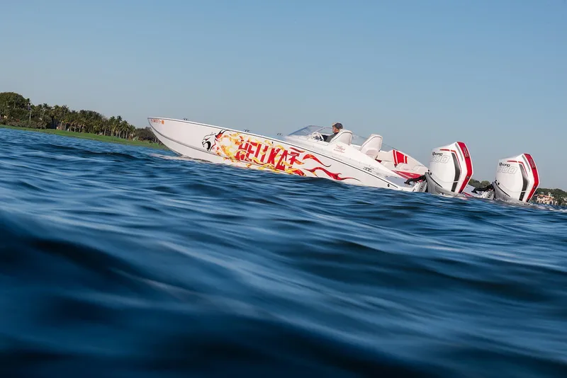 Slide: The Image of 2022 HellKats 32 speedboat with vibrant graphics cruising on open water. - 21