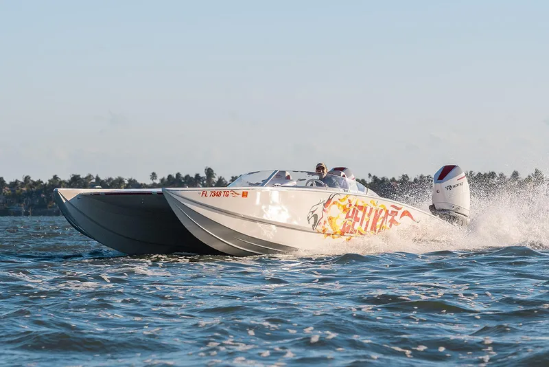 Slide: The Image of 2022 HellKats 32 powerboat speeding on water, featuring vibrant graphics and dual outboard engines. - 4