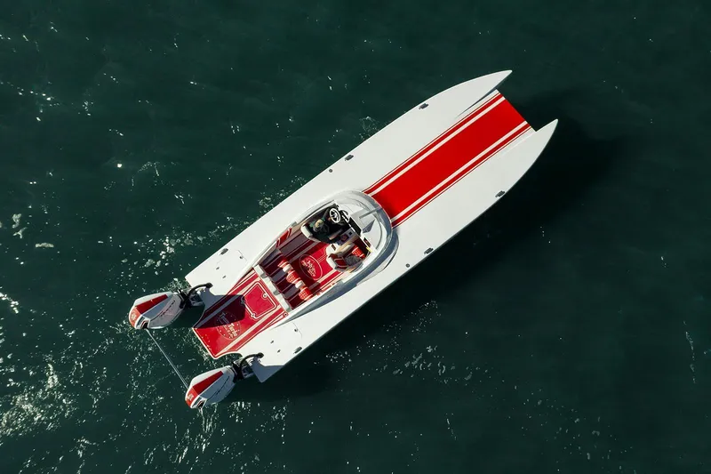 Slide: The Image of Aerial view of 2022 HellKats 32 speedboat with red and white design on water. - 5
