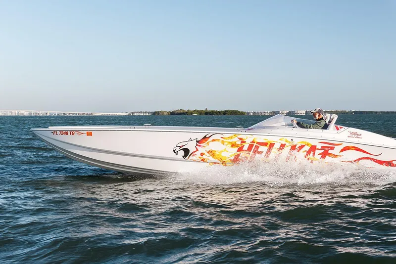 Slide: The Image of 2022 HellKats 32 speedboat with flame graphics cruising on open water. - 7
