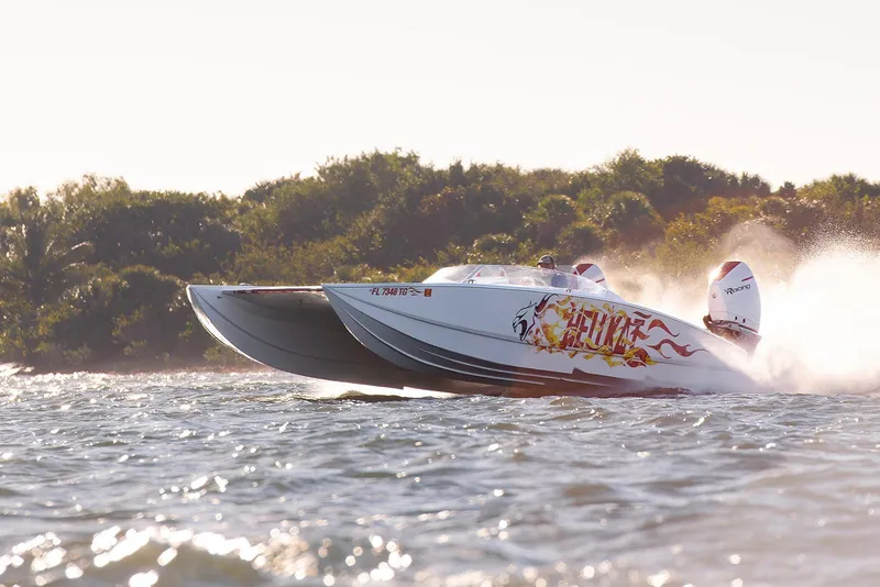 Slide: The Image of High-speed HellKats 32 powerboat racing on water, 2022 model, with vibrant graphics. - 8