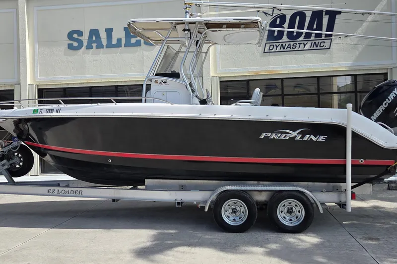 The Image of 2008 Pro-Line 24 Super Sport boat on trailer outside dealership. - 0