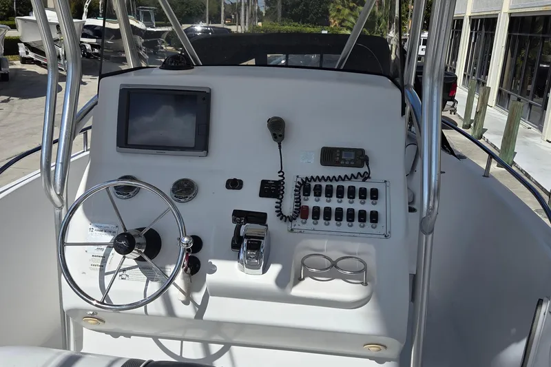 Slide: The Image of 2008 Pro-Line 24 Super Sport boat dashboard with steering wheel and control panel. - 10