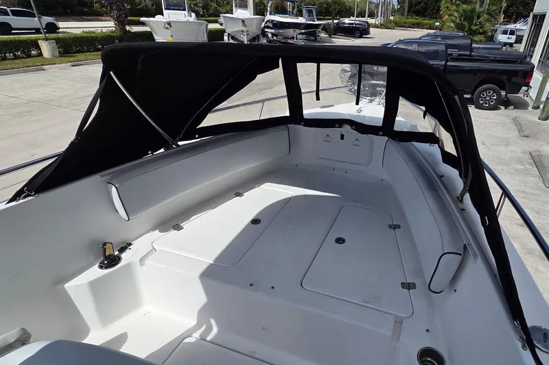 Slide: The Image of 2008 Pro-Line 24 Super Sport boat interior with black canopy and spacious seating area. - 12