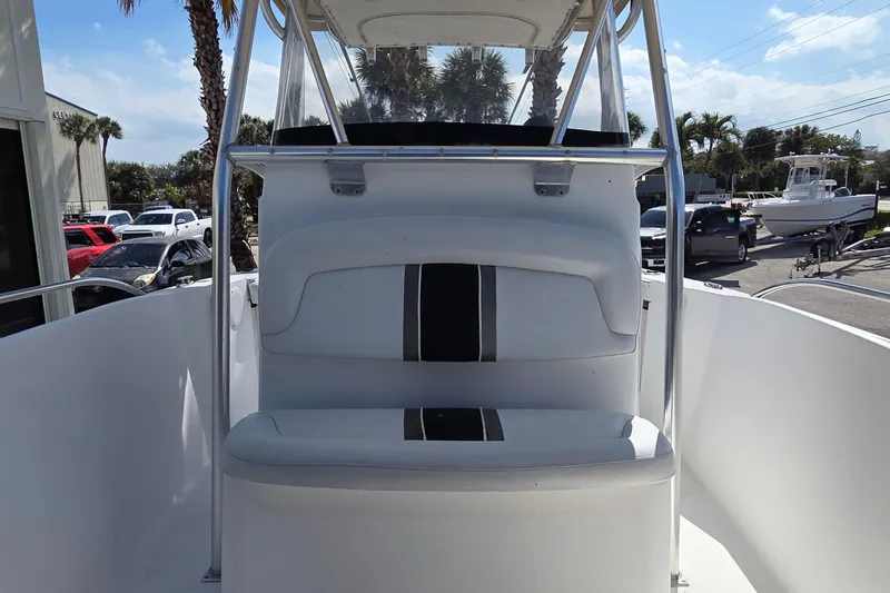 Slide: The Image of 2008 Pro-Line 24 Super Sport boat interior with seating and console, parked outdoors. - 13