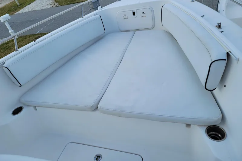 Slide: The Image of 2008 Pro-Line 24 Super Sport boat interior with white cushioned seating. - 17