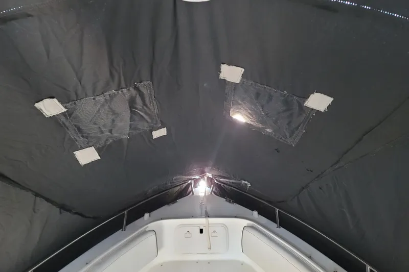 Slide: The Image of Interior view of 2008 Pro-Line 24 Super Sport boat with black canopy. - 20