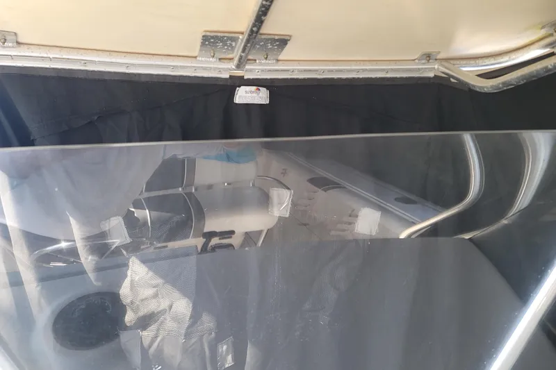 Slide: The Image of 2008 Pro-Line 24 Super Sport boat interior with protective cover and seating. - 21